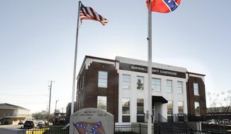 A Confederate monument and rebel battle flag are flown outside the Marshall County Courthouse in Albertville, Ala., on Wednesday, Dec. 9, 2020. Unique Morgan Dunston, a Black woman transformed by leaving the virtually all-white town where she grew up, has been leading demonstrations against the Old South commemoration since August. (AP Photo/Jay Reeves)