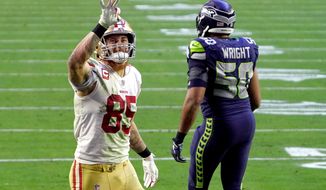 San Francisco 49ers tight end George Kittle (85) signals after a first down as Seattle Seahawks outside linebacker K.J. Wright (50) walks away during the second half of an NFL football game, Sunday, Jan. 3, 2021, in Glendale, Ariz. (AP Photo/Rick Scuteri)