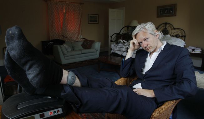 In this Wednesday, June 15, 2011, file photo, WikiLeaks founder Julian Assange is seen with his ankle security tag at the house where he is required to stay, near Bungay, England. Judge Vanessa Baraitser has ruled that Julian Assange cannot be extradited to the US. because of concerns about his mental health, it was reported on Monday, Jan. 4, 2021. (AP Photo/Kirsty Wigglesworth, File)