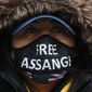 A Julian Assange supporter wears a face mask bearing his name outside the Old Bailey in London, Monday, Jan. 4, 2021. (AP Photo/Frank Augstein)