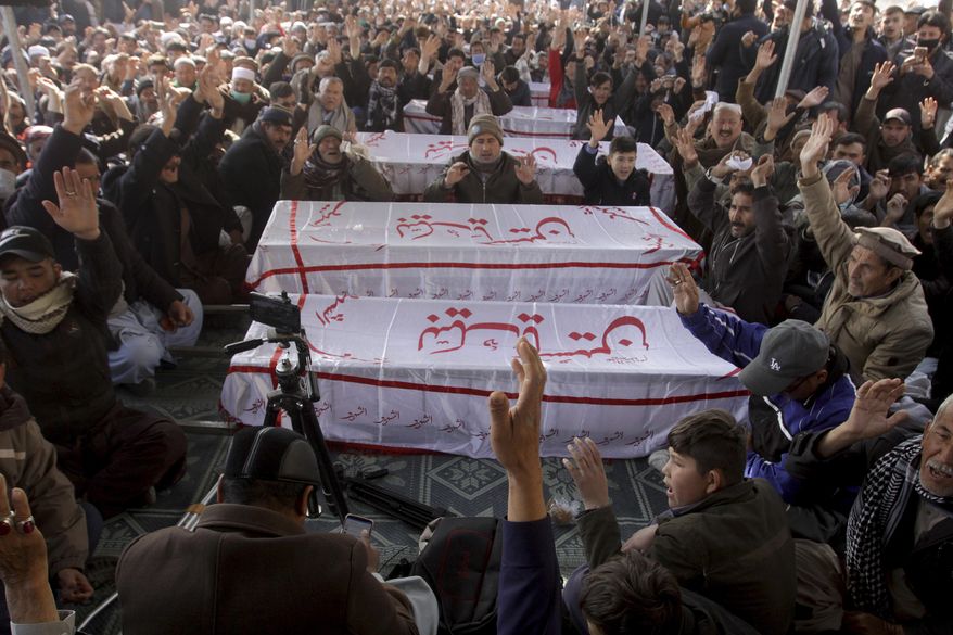 People from the Shiite Hazara community chant slogans beside caskets of coal mine workers who were killed by unknown gunmen near the Machh coal field, during a sit-in protest, in Quetta, Pakistan, Monday, Jan. 4, 2021. Gunmen opened fire on a group of minority Shiite Hazara coal miners after abducting them, killing 11 in southwestern Baluchistan province early Sunday, a Pakistani official said. (AP Photo/Arshad Butt)