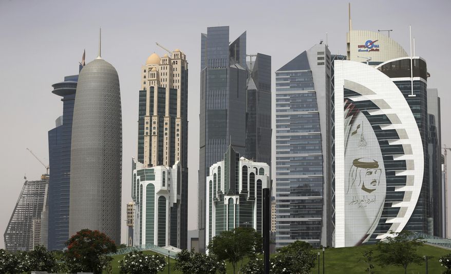 In this May 5, 2018, file photo, a giant image of the Emir of Qatar Sheikh Tamim bin Hamad Al Thani adorns a tower in Doha, Qatar. Kuwait’s foreign ministry announced Monday, Jan. 4, 2021, that Saudi Arabia will open its air and land borders with Qatar in the first steps toward ending a diplomatic crisis that has deeply divided regional U.S. allies since 2017. (AP Photo/Kamran Jebreili)