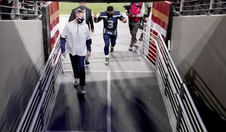 Seattle Seahawks quarterback Russell Wilson (3) leaves the field after an NFL football game against the San Francisco 49ers, Sunday, Jan. 3, 2021, in Glendale, Ariz. The Seahawks won 26-23. (AP Photo/Ross D. Franklin)