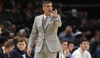 FILE - Villanova head coach Jay Wright gestures during the first half of an NCAA college basketball game against Georgetown in Washington, in this Saturday, March 7, 2020, file photo. Villanova coach Jay Wright was set to return to practice Tuesday following his bout with COVID-19. Those plans are on hold after two players tested positive Monday, Jan. 4, 2021, and the Wildcats were forced to postpone their next three games. (AP Photo/Nick Wass, File)