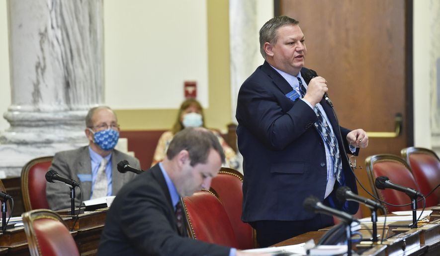 FILE - In this Dec. 7, 2020, file photo, Sen. Jason Ellsworth, R-Hamilton, speaks during a meeting of the Joint Rules Committee on the House floor of the Montana State Capitol, in Helena, Mont. As states brace for a coronavirus surge following holiday gatherings, one place stands out as a potential super-spreader site, the statehouses where lawmakers will help shape the response to the pandemic. (Thom Bridge/Independent Record via AP, File)
