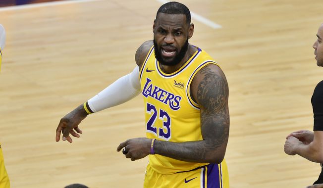 Los Angeles Lakers forward LeBron James (23) calls to teammates in the first half of an NBA basketball game against the Memphis Grizzlies Tuesday, Jan. 5, 2021, in Memphis, Tenn. (AP Photo/Brandon Dill)
