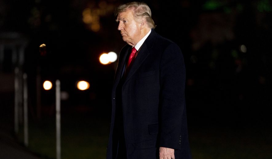 President Donald Trump arrives in the early morning hours, Tuesday, Jan. 5, 2021, at the White House in Washington, after returning from a rally in Dalton, Ga. (AP Photo/Andrew Harnik)