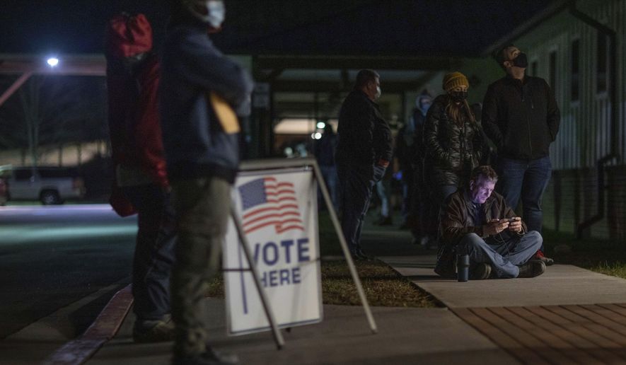 Voters wait in line to cast their ballots in Georgia&#39;s Senate runoff elections at a senior center, Tuesday, Jan. 5, 2021, in Acworth, Ga. (AP Photo/Branden Camp)