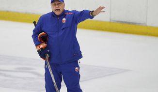FILE - In this July 13, 2020, file photo, New York Islanders head coach Barry Trotz give instructions during NHL hockey practice at the team&#39;s practice facility in East Meadow, N.Y. After winning just open playoff series in 26 years, the Islanders have advanced further in the postseason in each of the first two years under Trotz. (AP Photo/Kathy Willens, File)