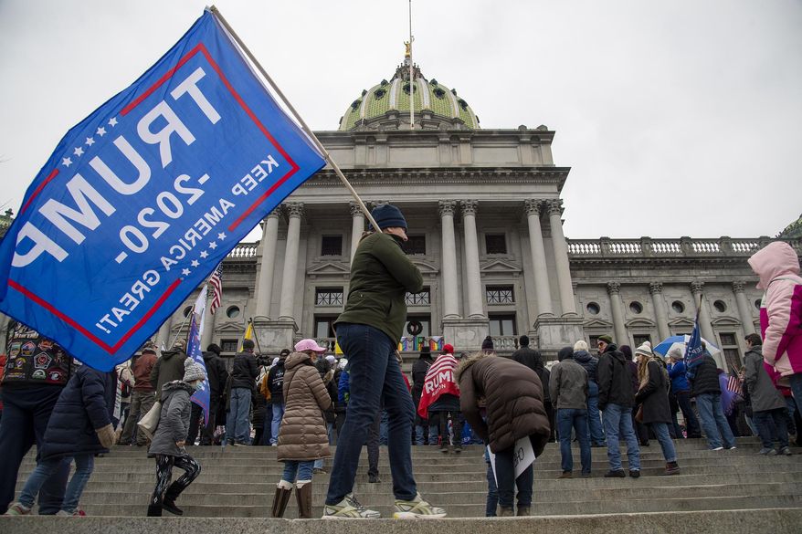 Trump supporters protest for Congress to de-certify election results during a rally on the steps of the Pennsylvania's State Capitol Building Harrisburg, Pa. Tuesday, Jan. 5, 2021. (Jose F. Moreno/The Philadelphia Inquirer via AP)