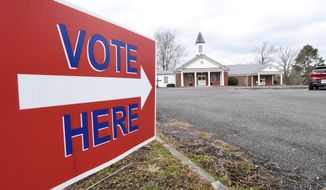 A sign at the street points voters to a polling place at Dawnville United Methodist Church in Dawnville, Ga., on Tuesday, Jan. 5, 2021. (Matt Hamilton/Chattanooga Times Free Press via AP)