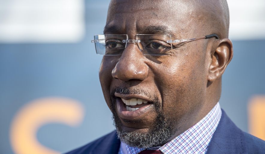 Georgia Democratic senate candidate Raphael Warnock talks to reporters following a campaign rally in Augusta, Ga., Monday, Jan. 4, 2021. Democrats Jon Ossoff and Warnock are challenging incumbent Republican Senators David Perdue and Kelly Loeffler in a runoff election on Jan. 5. (Michael Holahan/The Augusta Chronicle via AP)