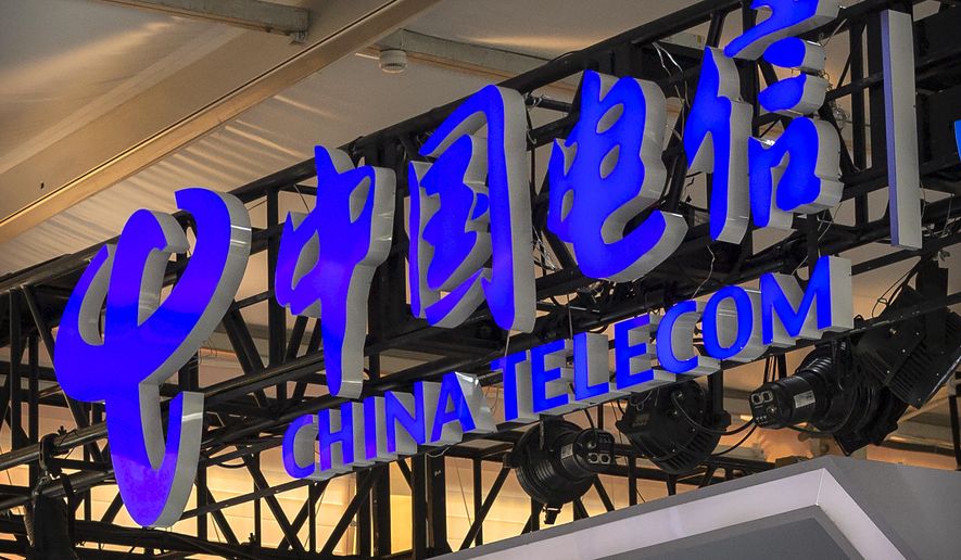 In this Sept. 5, 2020, file photo, the logo for Chinese telecommunications firm China Telecom is seen on a booth at the China International Fair for Trade in Services (CIFTIS) in Beijing.  (AP Photo/Mark Schiefelbein, File)  **FILE**