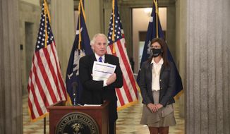 South Carolina Gov. Henry McMaster shows a listing of hospitals in the state that have received the COVID-19 vaccine during a news conference at the Statehouse in Columbia, South Carolina, on Tuesday, Jan. 5, 2021. McMaster wants health officials to set a Jan. 15 deadline to get vaccines before they open them to frontline workers and people over age 75. (AP Photo/Jeffrey Collins) **FILE**