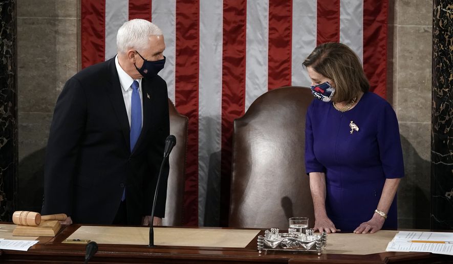 Speaker of the House Nancy Pelosi, D-Calif., and Vice President Mike Pence arrive to officiate as a joint session of the House and Senate convenes to count the Electoral College votes cast in November&#39;s election, at the Capitol in Washington, Wednesday, Jan. 6, 2021. (AP Photo/J. Scott Applewhite)