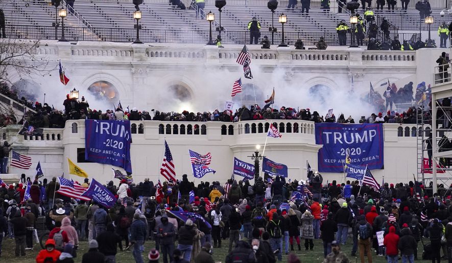 Violent protesters, loyal to President Donald Trump, storm the Capitol, Wednesday, Jan. 6, 2021, in Washington. It's been a stunning day as a number of lawmakers and then the mob of protesters tried to overturn America's presidential election, undercut the nation's democracy and keep Democrat Joe Biden from replacing Trump in the White House. (AP Photo/John Minchillo)