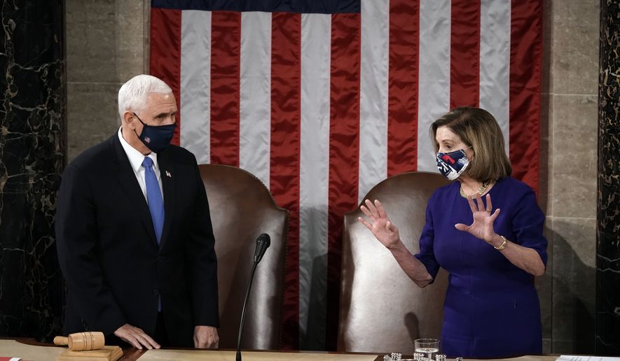 Speaker of the House Nancy Pelosi, D-Calif., and Vice President Mike Pence talk before a joint session of the House and Senate convenes to confirm the Electoral College votes cast in November&#x27;s election, at the Capitol in Washington, Wednesday, Jan. 6, 2021. (AP Photo/J. Scott Applewhite, Pool)