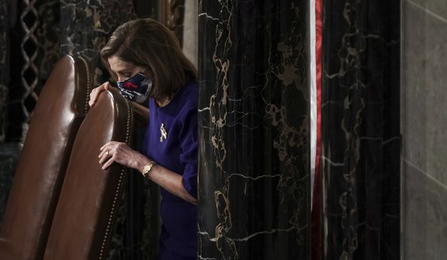 Speaker of the House Nancy Pelosi, D-Calif., calls the House in order prior to a joint session of the House and Senate convenes to confirm the Electoral College votes cast in November&#x27;s election, at the Capitol in Washington, Wednesday, Jan. 6, 2021. (Greg Nash/Pool via AP)