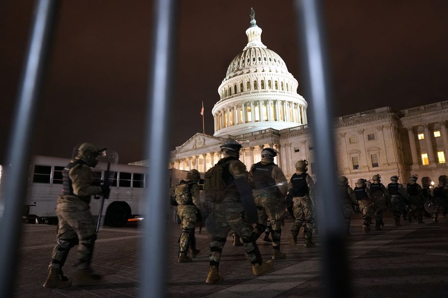 Members of the National Guard arrive to secure the area outside the U.S. Capitol, Wednesday, Jan. 6, 2021, in Washington. (AP Photo/Jacquelyn Martin)