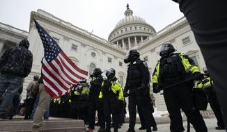 U.S. Capitol Police officers push back demonstrators who were trying to break into the U.S. Capitol on Wednesday, Jan. 6, 2021, in Washington. (AP Photo/Jose Luis Magana) **FILE**