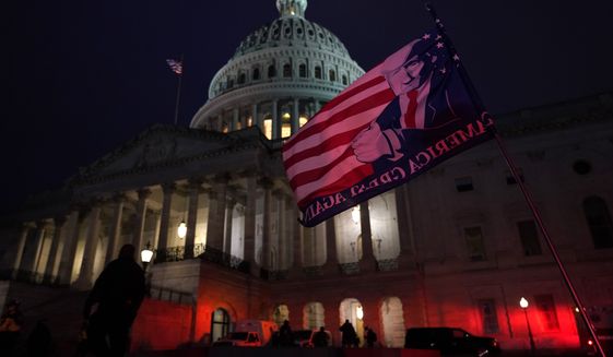 Authorities stand guard outside the U.S. Capitol after supporters of President Donald Trump gathered Wednesday, Jan. 6, 2021, in Washington. (AP Photo/Jacquelyn Martin)
