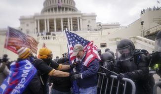 Trump supporters try to break through a police barrier, Wednesday, Jan. 6, 2021, at the Capitol in Washington. As Congress prepares to affirm President-elect Joe Biden&#39;s victory, thousands of people have gathered to show their support for President Donald Trump and his claims of election fraud. (AP Photo/John Minchillo) **FILE**