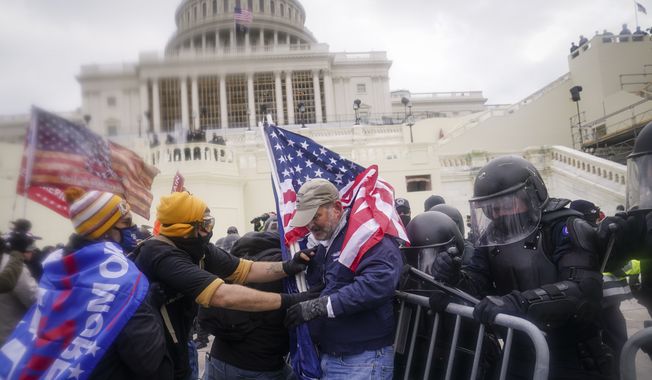 Trump supporters try to break through a police barrier, Wednesday, Jan. 6, 2021, at the Capitol in Washington. As Congress prepares to affirm President-elect Joe Biden&#x27;s victory, thousands of people have gathered to show their support for President Donald Trump and his claims of election fraud. (AP Photo/John Minchillo) **FILE**