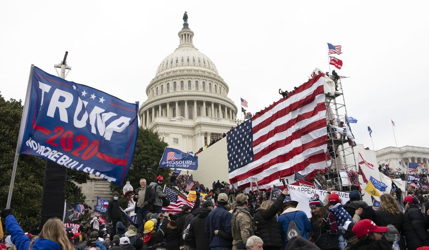 Supporters of President Donald Trump stand outside the U.S. Capitol on Wednesday, Jan. 6, 2021, in Washington. (AP Photo/Jose Luis Magana) **FILE**