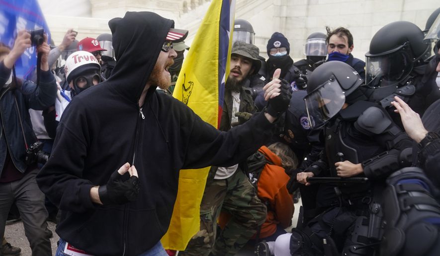 Trump supporters try to break through a police barrier, Wednesday, Jan. 6, 2021, at the Capitol in Washington. As Congress prepares to affirm President-elect Joe Biden's victory, thousands of people have gathered to show their support for President Donald Trump and his claims of election fraud. (AP Photo/John Minchillo)