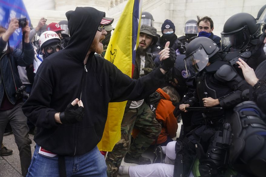 Trump supporters try to break through a police barrier, Wednesday, Jan. 6, 2021, at the Capitol in Washington. As Congress prepares to affirm President-elect Joe Biden&#39;s victory, thousands of people have gathered to show their support for President Donald Trump and his claims of election fraud. (AP Photo/John Minchillo)