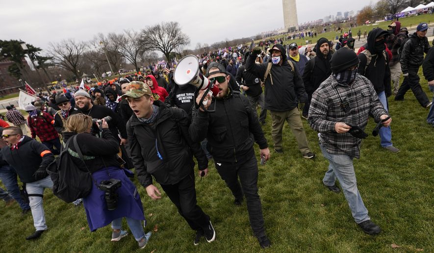 People march with those who claim they are members of the Proud Boys as they attend a rally in Washington, Wednesday, Jan. 6, 2021, in support of President Donald Trump. (AP Photo/Carolyn Kaster)