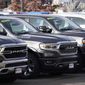A long row of unsold 2020 pickup trucks sits at a Ram dealership Sunday, Dec. 27, 2020, in Littleton, Colo.  A new government report says gas mileage for new vehicles dropped and pollution increased in model year 2019 for the first time in five years.  (AP Photo/David Zalubowski)