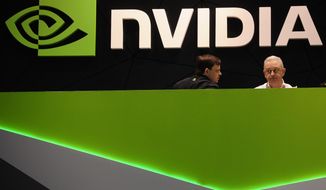 FILE - In this file photo dated Thursday, Feb. 27, 2014, people gather in the Nvidia booth at the Mobile World Congress mobile phone trade show in Barcelona, Spain.  U.K regulators said Wednesday Jan. 6, 2021, they are investigating graphics computer chip maker Nvidia&#39;s $40 billion purchase of chip designer Arm Holdings over concerns about its effect on competition.  (AP Photo/Manu Fernandez, FILE)
