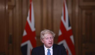 FILE - In this Jan. 5, 2021, file photo, Britain&#39;s Prime Minister Boris Johnson speaks during a news conference inside 10 Downing Street in London. World leaders, including Johnson, are condemning the storming of the U.S. Capitol by supporters of President Donald Trump. (Hannah McKay/Pool Photo via AP, File)