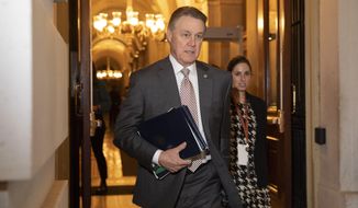 FILE - In this Jan. 31, 2020, file photo, Sen. David Perdue, R-Ga., leaves Capitol Hill in Washington. Perdue has taken down a digital campaign ad featuring a manipulated picture of his Democratic opponent, Jon Ossoff, who is Jewish, with an enlarged nose. A spokeswoman for Perdue said in a statement Monday, July 27, 2020, that the image has been removed from Facebook, calling it an “unintentional error” by an outside vendor, without naming the vendor. (AP Photo/Jacquelyn Martin, File)
