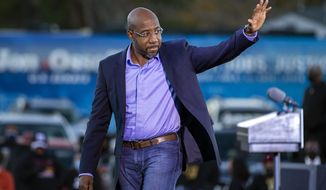 Democratic U.S. Senate candidate Rev. Raphael Warnock waves to supporters during a drive-in rally, Sunday, Jan. 3, 2021, in Savannah, Ga. Vice President-elect Kamala Harris made a campaign stop for Georgia candidates Warnock and Jon Ossoff before the runoff election Tuesday. (AP Photo/Stephen B. Morton)