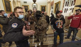 Supporters of President Donald Trump are confronted by Capitol Police officers outside the Senate Chamber at the Capitol, Wednesday, Jan. 6, 2021, in Washington. (AP Photo/Manuel Balce Ceneta) **FILE**