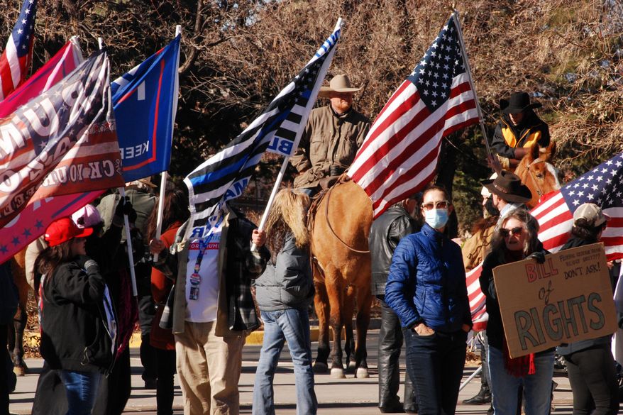 Supporters of President Donald Trump gather at the Statehouse in Santa Fe, N.M., on Wednesday, Jan. 6, 2021, to protest President-elect Joe Biden's electoral victory. (AP Photo/Morgan Lee)