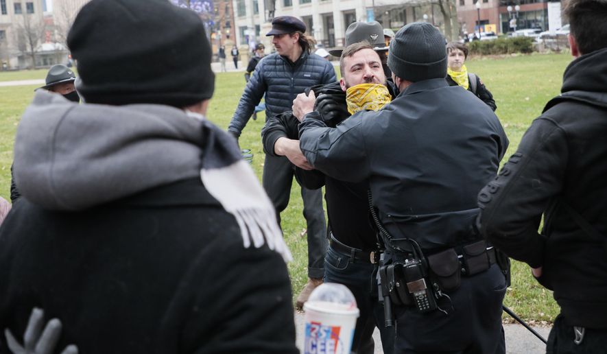 Law enforcement personnel restrain a member of the Proud Boys as a fight breaks out during a "Stop the Steal" rally on Wednesday, Jan. 6, 2021, at the Ohio Statehouse in Columbus, Ohio. Hundreds of supporters of President Donald Trump came to the Statehouse to protest the congressional certification of Democratic President-elect Joe Biden. (Joshua A. Bickel/The Columbus Dispatch via AP)
