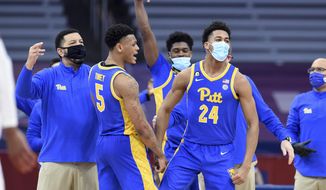 The Pittsburgh bench celebrates after Pitt tied the score against Syracuse in an NCAA college basketball game Wednesday, Jan. 6, 2021, in Syracuse, N.Y. (Dennis Nett/The Post-Standard via AP)
