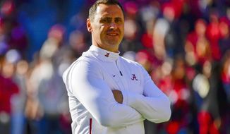 FILE - In this Nov. 9, 2019, file photo, Alabama offensive coordinator Steve Sarkisian watches warmups before an NCAA football game against LSU in Tuscaloosa, Ala. Texas has hired Sarkisian as the Longhorns new coach. The move comes just a few hours after Texas announced the firing of Tom Herman after four seasons with no Big 12 championships. (AP Photo/Vasha Hunt, File)