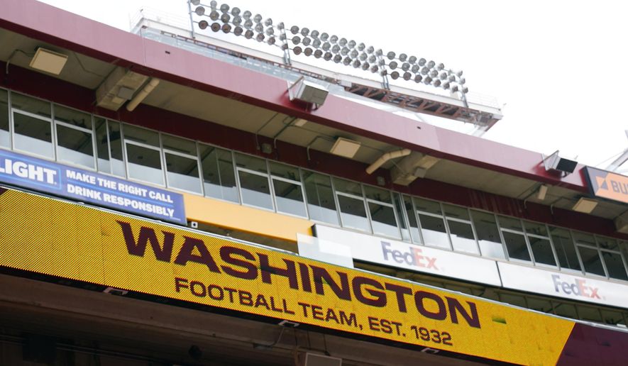 Fedex Field scoreboard displays the Washington Football Team name during warmups before the start of a NFL football game between Washington Football Team and Philadelphia Eagles, Sunday, Sept. 13, 2020, in Landover, Md. Washington has dumped its 86-year-old team name, handed over an investigation into workplace misconduct to the NFL, seen minority owners and Dan Snyder battle it out in court, coach Ron Rivera battle a form of skin cancer and reached the playoffs on the arm of a quarterback who hadn&#x27;t played in two years because of an injury that looked career-threatening. All in a few months&#x27; work for arguably the biggest soap opera in professional sports with a playoff game against Tom Brady up next. (AP Photo/Susan Walsh) **FILE**