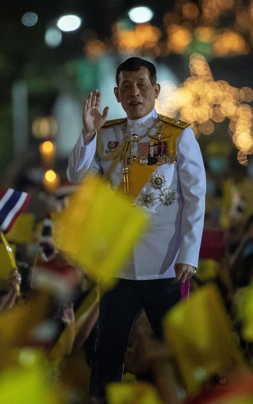 Thai King Maha Vajiralongkorn, 68, faces a balancing act to maintain his position of strength during 2021 while trying to adapt to an increasingly international public spotlight.
greets supporters as he walks to participate in a candle lighting ceremony to mark the anniversary of the birth of late King Bhumibol Adulyadej at Sanam Luang ceremonial ground in Bangkok, Thailand, Saturday, Dec. 5, 2020. Thousands of yellow-clad supporters greeted Thailand&#39;s king in Bangkok on Saturday as he led a birthday commemoration for his revered late father, the latest in a series of public appearances at a time of unprecedented challenge to the monarchy from student-led protesters.(AP Photo/Gemunu Amarasinghe) (ASSOCIATED PRESS PHOTOGRAPHS)