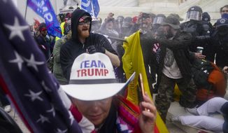 Trump supporters try to break through a police barrier, Wednesday, Jan. 6, 2021, at the Capitol in Washington. As Congress prepared to affirm President-elect Joe Biden&#39;s victory, thousands of people gathered to show their support for President Donald Trump and his claims of election fraud.(AP Photo/John Minchillo)