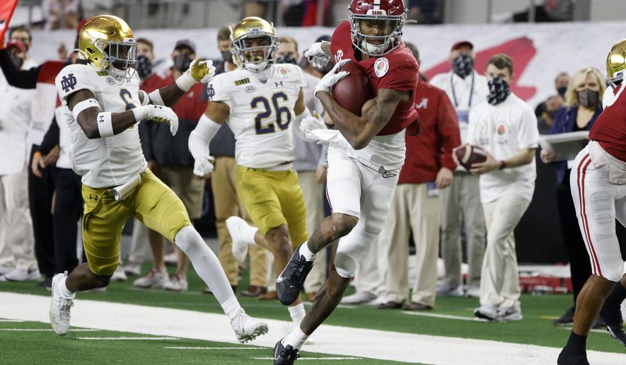 FILE - Alabama wide receiver DeVonta Smith (6) gets past Notre Dame linebacker Jeremiah Owusu-Koramoah (6) and cornerback Clarence Lewis (26) on his way to the end zone for a touchdown in the first half of the Rose Bowl NCAA college football game in Arlington, Texas, in this Friday, Jan. 1, 2021, file photo. The Heisman Trophy winner caught seven passes for 130 yards and three touchdowns as No. 1 Alabama beat No. 4 Notre Dame in a College Football Playoff semifinal.(AP Photo/Michael Ainsworth, File)