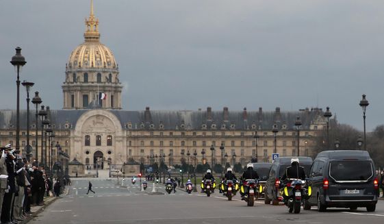 The hearse convoy of late French forces soldiers , who were killed in Mali when an improvised explosive device hit their armored vehicle last week, rides on his way to the Invalides for a national tribute, in Paris, Monday, Jan. 4, 2021. The soldiers were participating in a military operation in the Hombori area of Mali&#39;s central Mopti province, part of a larger mission aiming at fighting Islamist extremists in Africa&#39;s Sahel region, as part of Operation Barkhane. (AP Photo/Francois Mori)