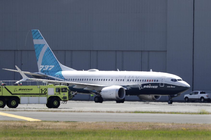 FILE - In this Monday, June 29, 2020, file photo, A Boeing 737 MAX jet taxis after landing at Boeing Field following a test flight in Seattle. Boeing will pay $2.5 billion to settle a criminal charge related to its troubled 737 Max jetliner. The Justice Department announced the settlement Thursday, Jan. 7, 2021 nearly two years after the second of two crashes that killed 346 people in all. (AP Photo/Elaine Thompson)