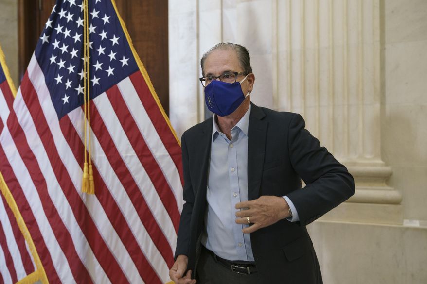 Sen. Mike Braun, R-Ind., departs after the Republican Conference held leadership elections, on Capitol Hill in Washington, Tuesday, Nov. 10, 2020. (AP Photo/J. Scott Applewhite)