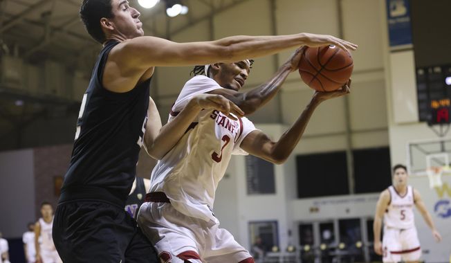 CORRECTS YEAR TO 2021 NOT 2020 - Washington center Riley Sorn (52), left, defends a shot against Stanford forward Ziaire Williams (3) during the first half of an NCAA college basketball game in Santa Cruz, Calif., Thursday, Jan. 7, 2021. (AP Photo/Josie Lepe)