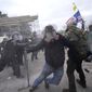 Trump supporters try to break through a police barrier, Wednesday, Jan. 6, 2021, at the Capitol in Washington. As Congress prepares to affirm President-elect Joe Biden's victory, thousands of people have gathered to show their support for President Donald Trump and his claims of election fraud. (AP Photo/Julio Cortez)
